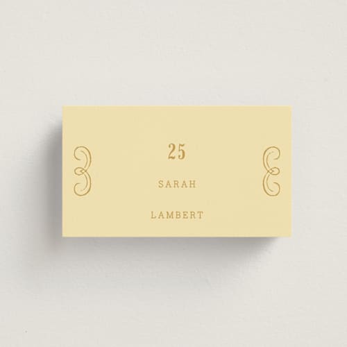 This is a butter wedding place cards with standard by Nazia Hyder called vintage label printing on signature in placecard
