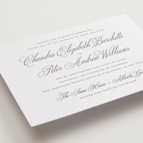This is a graphite letterpress wedding invitations with letterpress by Wildfield Paper Co called calligraphie printing on white cotton in standard