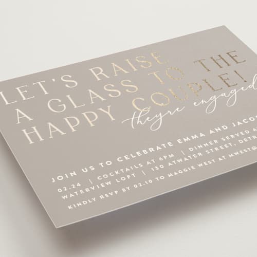 This is a buttercream engagement party invitations with foil pressed by Lisa Assenmacher called let's raise a glass printing on signature in standard