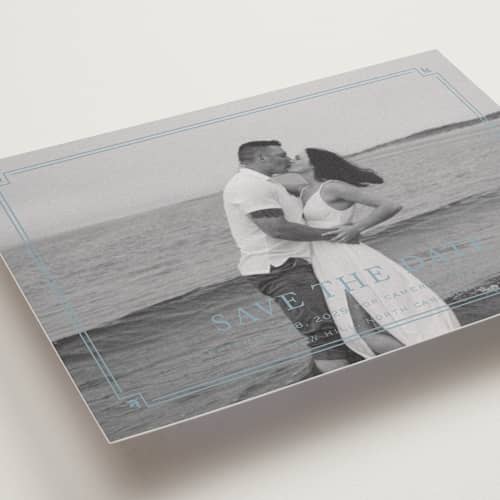 This is a french blue save the date with standard by Carolyn MacLaren called fleur corner printing on recycled smooth signature in grand