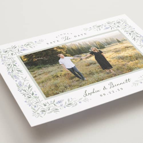 This is a periwinkle save the date with standard by Kristen Smith called delicate vines printing on recycled smooth signature in grand