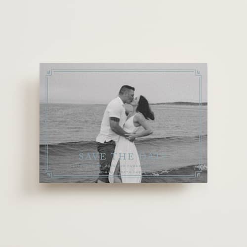 This is a french blue petite save the dates with standard by Carolyn MacLaren called fleur corner printing on recycled smooth signature in petite