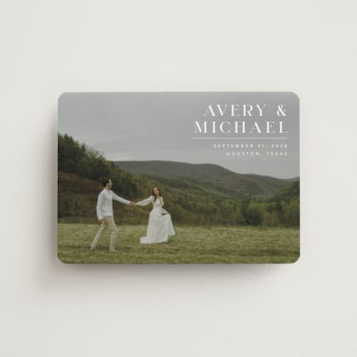 This is a ivory save the date magnets with standard by Juneau Designs called hold tight printing on magnet paper in magnet