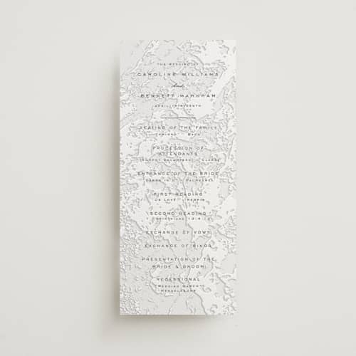 This is a soft black | blind deboss unique wedding programs with letterpress by Erin L. Wilson called subtle marble printing on white cotton in 4x9