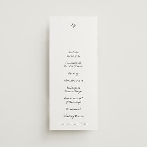 This is a soft black unique wedding programs with letterpress by Blustery August called lover's lantern printing on white cotton in 4x9