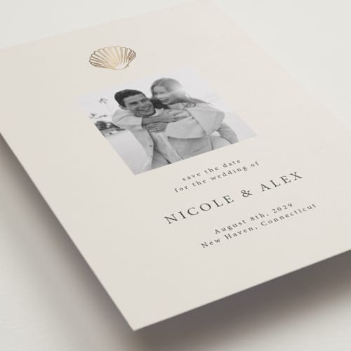 This is a sand foil stamped save the date cards with foil pressed by Hannah Bowman called simple seashell printing on recycled smooth signature in standard
