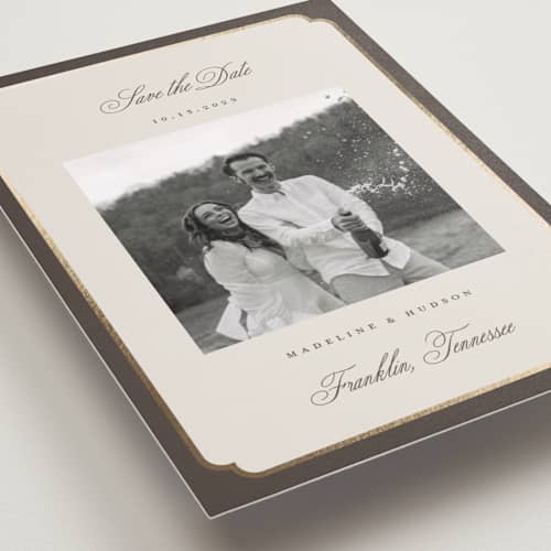 This is a cognac foil stamped save the date cards with foil pressed by Emily Betts called arch frame printing on recycled smooth signature in standard