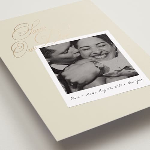 This is a linen foil stamped save the date cards with foil pressed by Lori Wemple called polaroid script printing on recycled smooth signature in standard