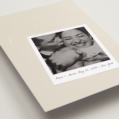 This is a linen foil stamped save the date cards with foil pressed by Lori Wemple called polaroid script printing on recycled smooth signature in standard