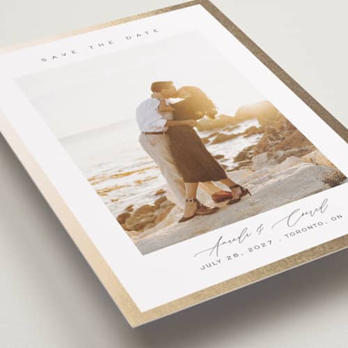 This is a vanilla foil stamped save the date cards with foil pressed by Nicole Walsh called glimmer printing on recycled smooth signature in standard