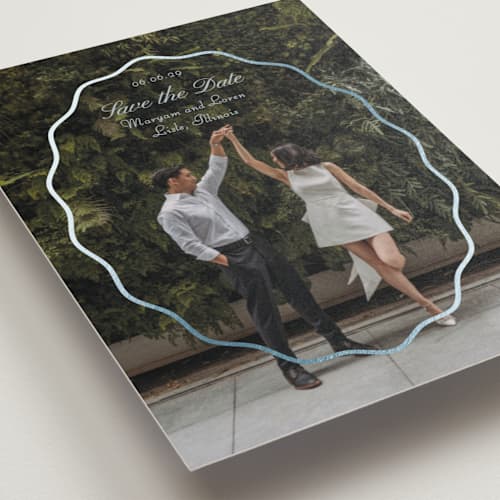 This is a periwinkle foil stamped save the date cards with foil pressed by Baumbirdy called scallop frame printing on recycled smooth signature in standard