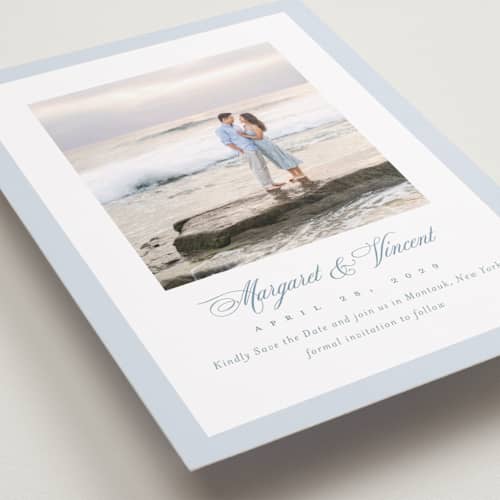 This is a dusty blue save the date with standard by Jennifer Postorino called coastal charm printing on recycled smooth signature in standard