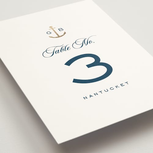 This is a royal navy table numbers with foil pressed by Olivia Raufman called anchored printing on doublethick in standard