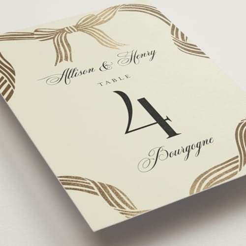 This is a champagne table numbers with foil pressed by Chris Griffith called all tied up printing on doublethick in standard