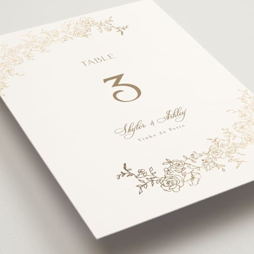 This is a champagne table numbers with foil pressed by Cass Loh called floral crest printing on doublethick in standard
