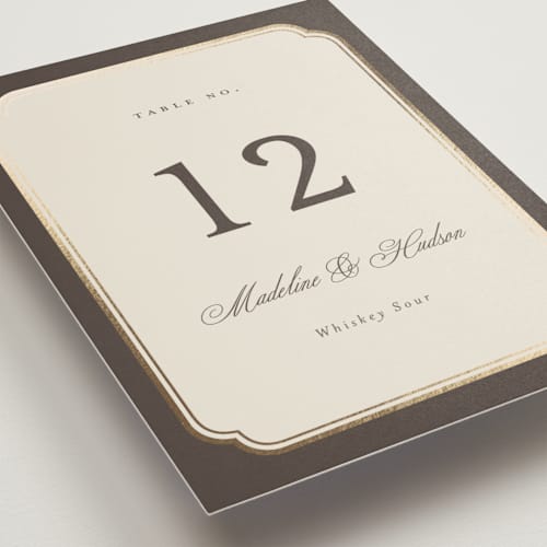 This is a cognac table numbers with foil pressed by Emily Betts called arch frame printing on doublethick in standard