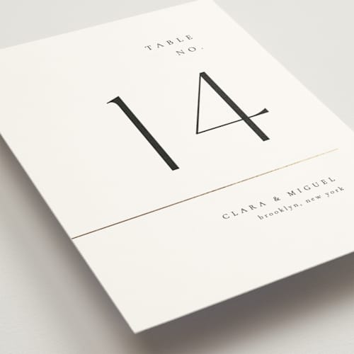 This is a silk table numbers with foil pressed by Kelly Schmidt called golden ampersand printing on doublethick in standard