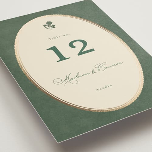 This is a rosemary table numbers with foil pressed by Emily Betts called vintage oval printing on doublethick in standard