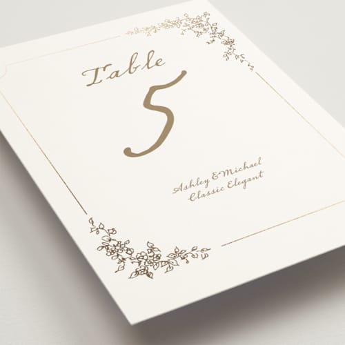 This is a ivory table numbers with foil pressed by Cass Loh called boho flower crest printing on doublethick in standard