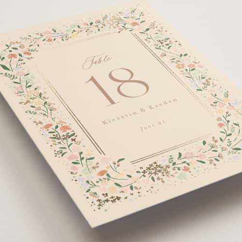 This is a ivory table numbers with foil pressed by Jennifer Wick called esther's garden printing on doublethick in standard