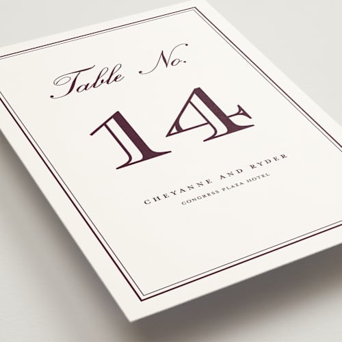 This is a burgundy table numbers with standard by Stacey Meacham called engraved names printing on doublethick in standard