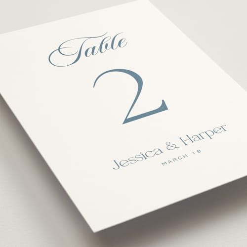 This is a dusty blue table numbers with standard by Jennifer Postorino called modern romance printing on doublethick in standard