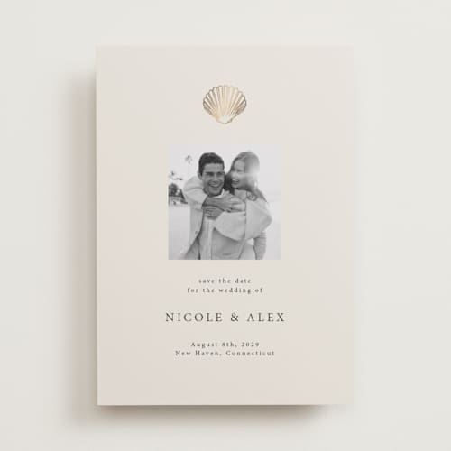 This is a sand foil stamped save the date cards with foil pressed by Hannah Bowman called simple seashell printing on recycled smooth signature in standard