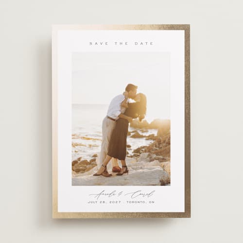 This is a vanilla foil stamped save the date cards with foil pressed by Nicole Walsh called glimmer printing on recycled smooth signature in standard