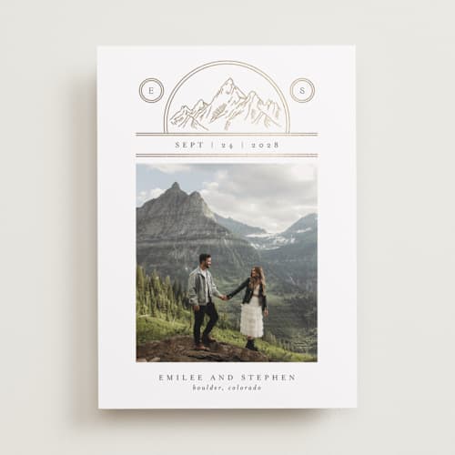 This is a chiffon foil stamped save the date cards with foil pressed by Heather Schertzer called mountaintop crest printing on recycled smooth signature in standard