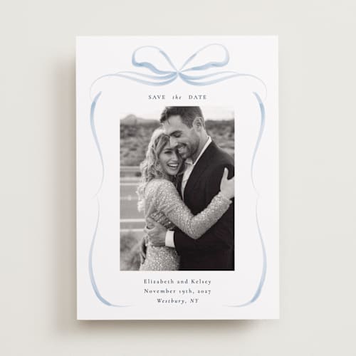 This is a dusty blue save the date with standard by Corinne Malesic called bow printing on recycled smooth signature in standard