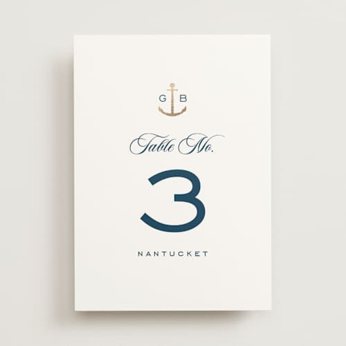 This is a royal navy table numbers with foil pressed by Olivia Raufman called anchored printing on doublethick in standard