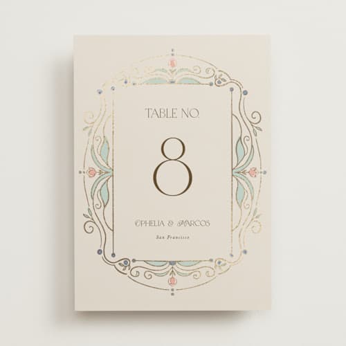 This is a ivory table numbers with foil pressed by Maria Hilas-Louie called ornate elegance printing on doublethick in standard