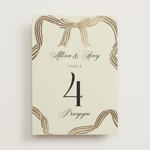 This is a champagne table numbers with foil pressed by Chris Griffith called all tied up printing on doublethick in standard