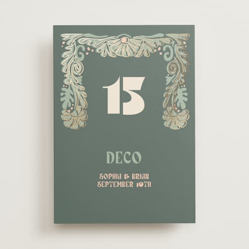 This is a sage table numbers with foil pressed by GeekInk Design called nouveau frame printing on doublethick in standard