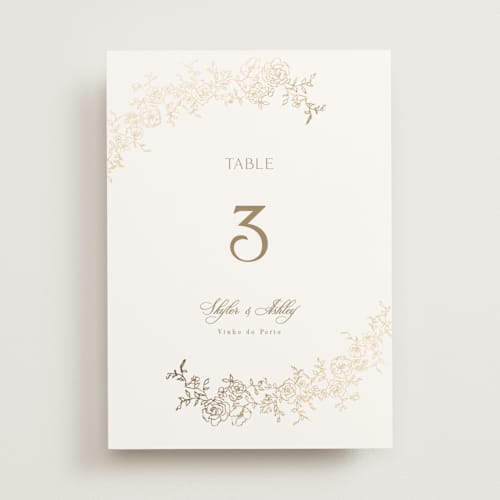 This is a champagne table numbers with foil pressed by Cass Loh called floral crest printing on doublethick in standard