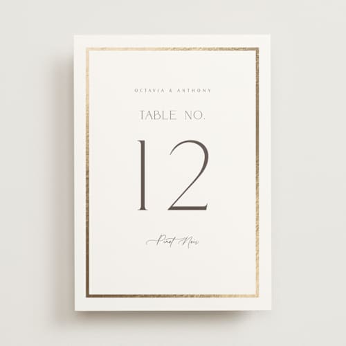 This is a porcelain table numbers with foil pressed by Nicole Walsh called regal printing on doublethick in standard