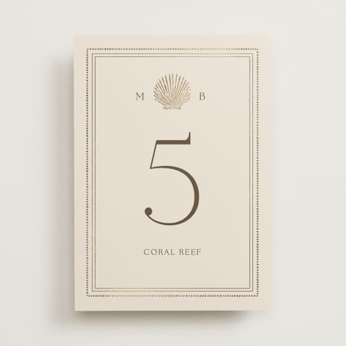 This is a champagne table numbers with foil pressed by Griffinbell Paper Co. called seaside printing on doublethick in standard