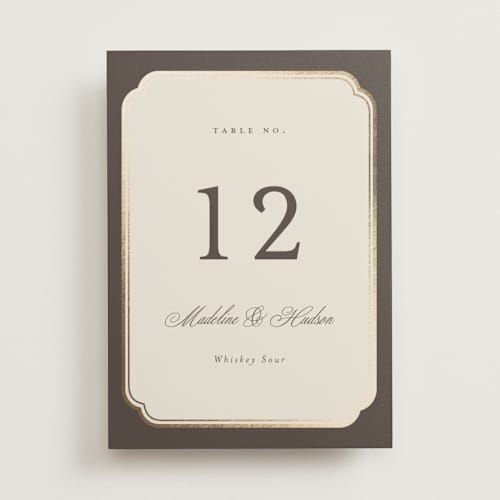 This is a cognac table numbers with foil pressed by Emily Betts called arch frame printing on doublethick in standard