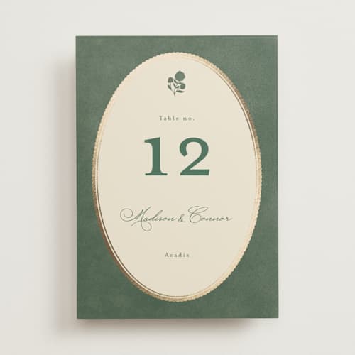 This is a rosemary table numbers with foil pressed by Emily Betts called vintage oval printing on doublethick in standard