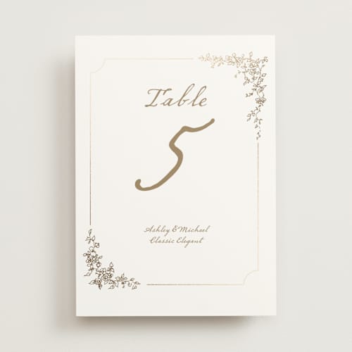 This is a ivory table numbers with foil pressed by Cass Loh called boho flower crest printing on doublethick in standard