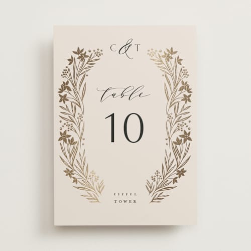 This is a champagne table numbers with foil pressed by Leah Bisch called floral border printing on doublethick in standard