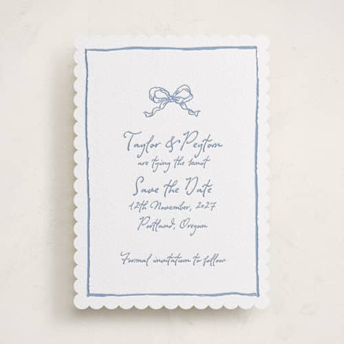 This is a pacific blue save the date with letterpress by Cass Loh called ribbon bow drawing printing on white cotton in standard