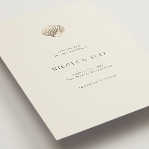 This is a sand foil stamped save the date cards with foil pressed by Hannah Bowman called simple seashell printing on signature in grand