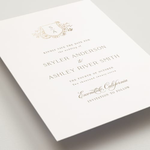 This is a champagne petite save the dates with foil pressed by Cass Loh called floral crest printing on signature in petite