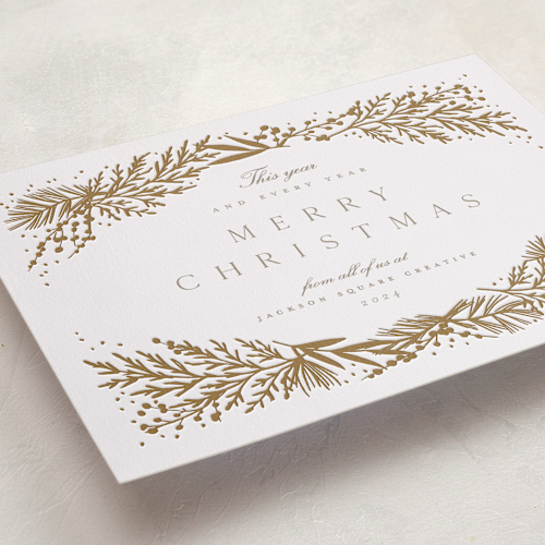 This is a golden letterpress holiday cards with letterpress by Amy Kross called spread cedars printing on bright white letterpress paper in standard