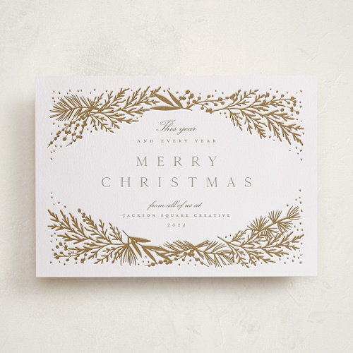 This is a golden letterpress holiday cards with letterpress by Amy Kross called spread cedars printing on bright white letterpress paper in standard