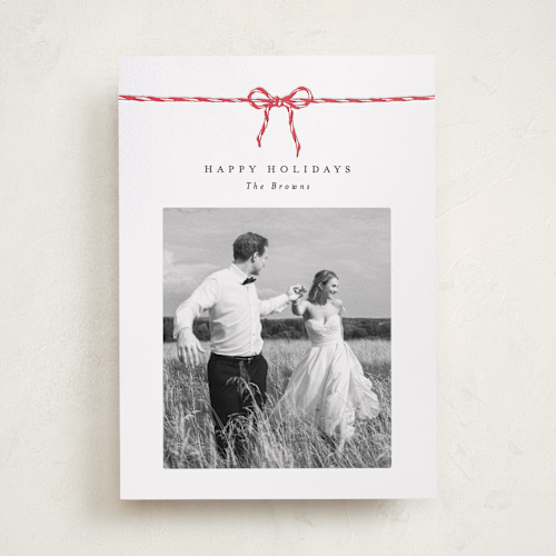 This is a peppermint letterpress holiday cards with letterpress by AK Graphics called with a bow printing on bright white letterpress paper in standard