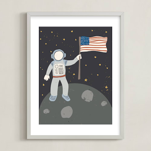 This is a muted blue kids wall art by Maggie Unruh called up in space astronaut