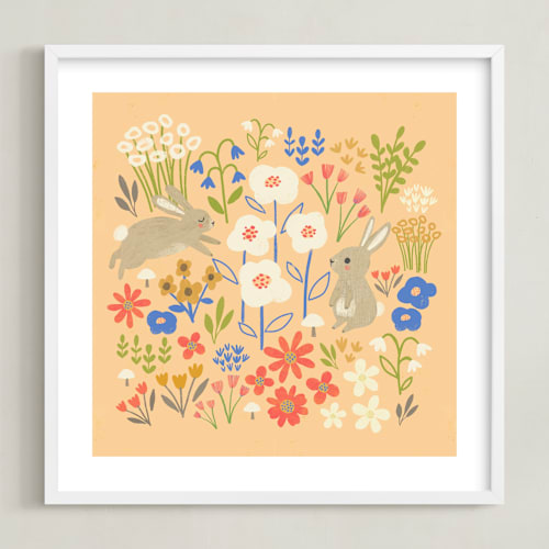 This is a peach kids wall art by Anne Lehman Stolpe called bunnies in the garden