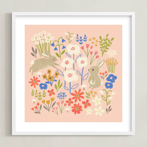 This is a light pink kids wall art by Anne Lehman Stolpe called bunnies in the garden